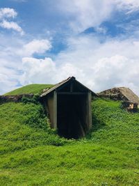 Built structure on field against sky