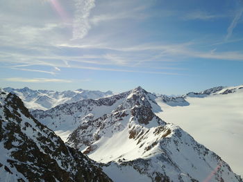 Scenic view of snowcapped mountains against sky