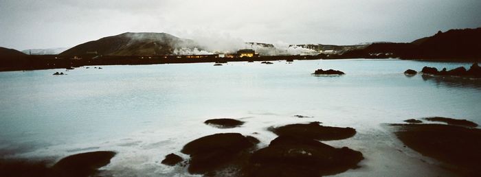 Scenic view of lake against sky during winter