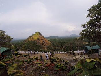 Group of people on landscape against the sky