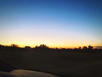 Scenic view of silhouette landscape against clear sky during sunset