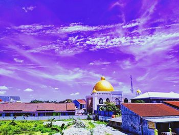 Panoramic view of buildings against blue sky