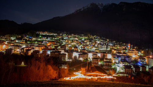 High angle view of illuminated buildings in city at night