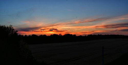 Scenic view of silhouette landscape against sky at sunset