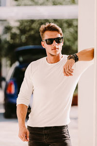 Young man wearing sunglasses standing outdoors