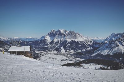 Scenic view of snowcapped mountains against clear blue sky