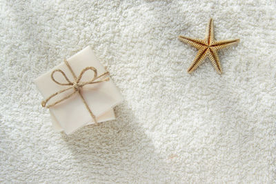 Directly above shot of soap bars and starfish on white towel