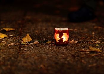 Close-up of burning candles on wood
