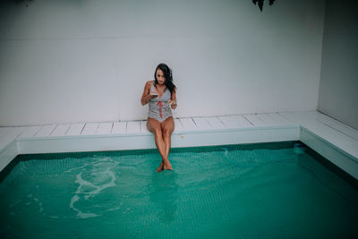 Woman standing in swimming pool