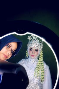 Reflection of bride and girl in mirror