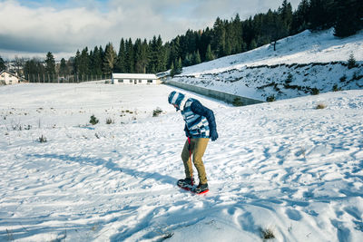 Full length of man snowboarding on snow