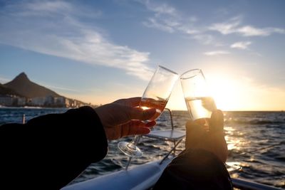 Celebrating with champagne on a boat watching sunset 