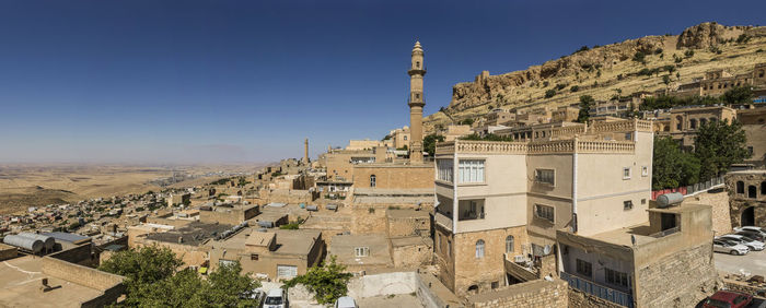Panoramic view of buildings in city against clear sky