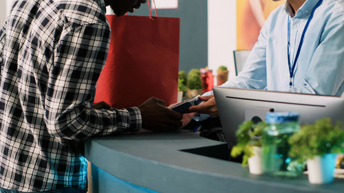 Midsection of man using laptop