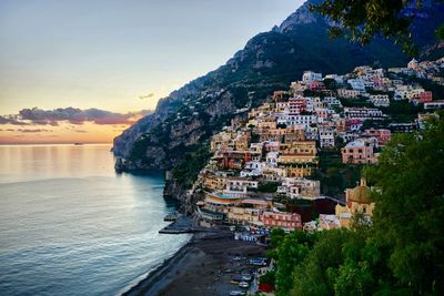 Scenic view of sea and mountains against sky