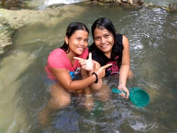 Portrait of a smiling young woman in water