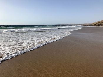 Scenic view of beach against clear sky