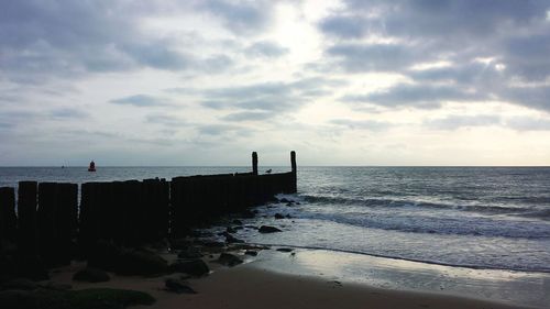 Scenic view of sea against cloudy sky
