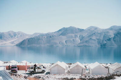 Panoramic view of lake and mountains against clear sky