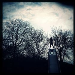 Low angle view of bare tree against sky