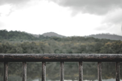 Close-up of metal fence against sky