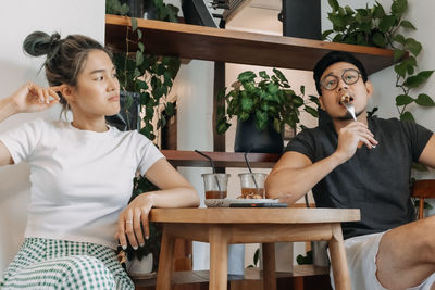 Mother and daughter sitting at home