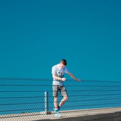 Full length of man against blue sky