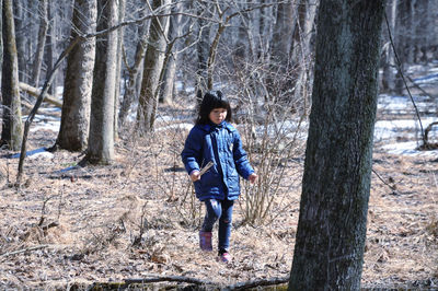 Full length of girl walking in forest