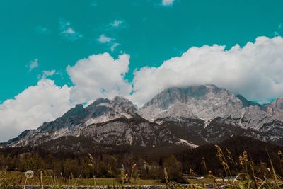 Scenic view of snowcapped mountains against cloudy sky