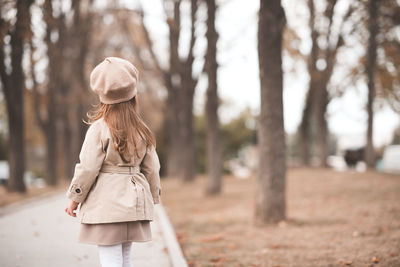 Rear view of girl looking standing at park