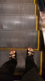 Low section of man on escalator