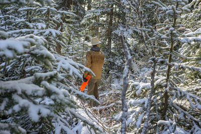 Man standing in snowy forest scene