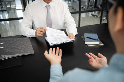 Midsection of businessman working at office