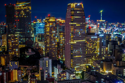 High angle view of illuminated buildings in city at night