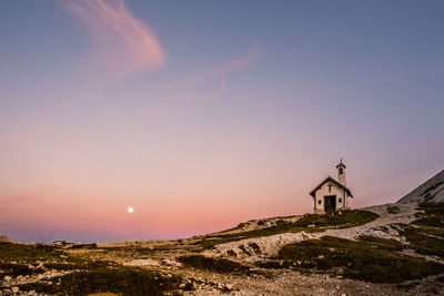 Scenic view of building against sky during sunset