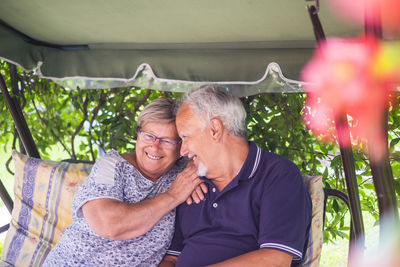 Couple embracing while sitting in garden