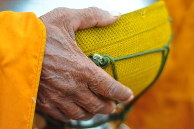 Cropped hand of man holding bowl