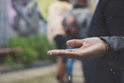 Close-up of human hand against blurred background