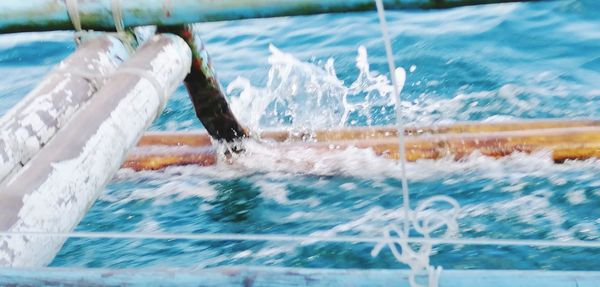 People in swimming pool against sea