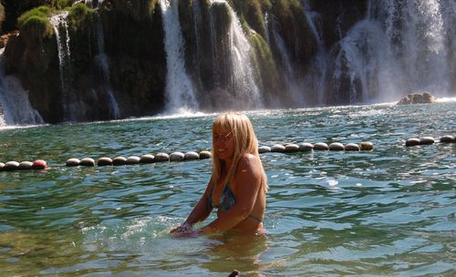 Woman in waterfall