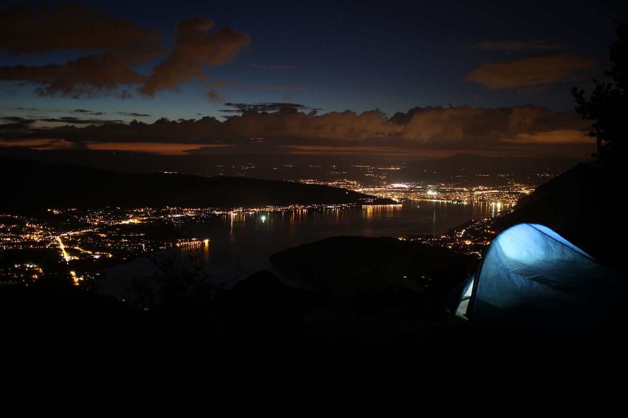 HIGH ANGLE VIEW OF ILLUMINATED BUILDINGS AT NIGHT