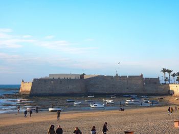 People at seaside with city in background