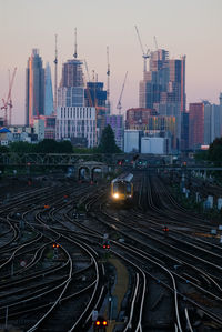 High angle view of railroad tracks amidst buildings in city