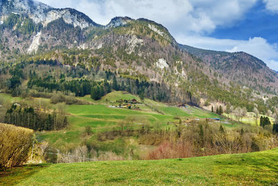 Scenic view of landscape and mountains against sky