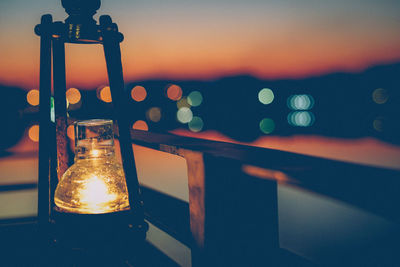 Close-up of illuminated light bulb on table