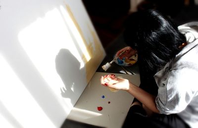 High angle view of woman painting at home