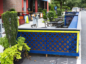 Potted plants on table by building in city