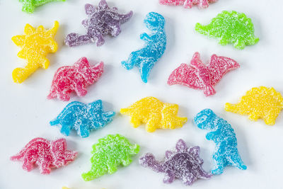Dinosaurs jelly bonn, candies on the white background, colorful jelly