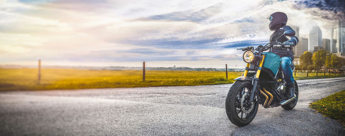 Man riding motorcycle on road