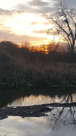 Scenic view of lake against sky during sunset